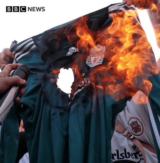 BBC News image of football protestors burning shirts